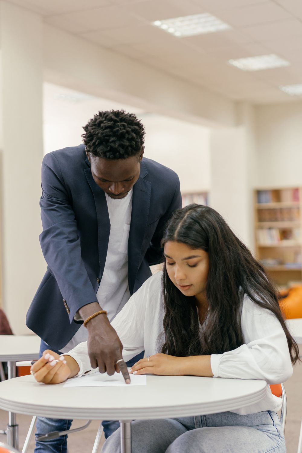 A mentor helping a student with coursework