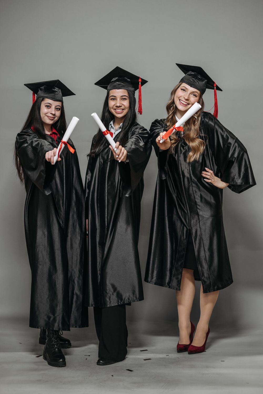 Graduates holding their diplomas after a ceremony