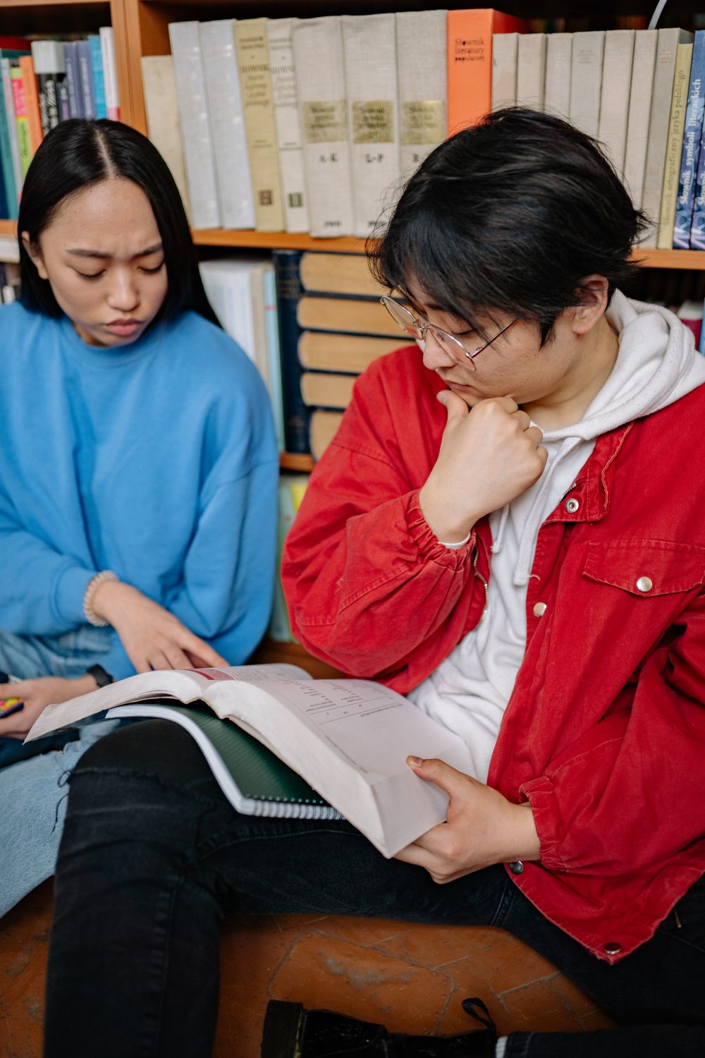 Students reading together in a library